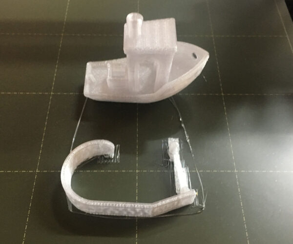 Clear PETG benchy - note the skirt loop doesn't adhere to the bed. 