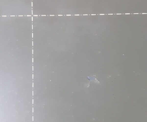 Coating came off the sheet. Leaving what looks like a hole. Top view.